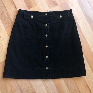 Black corduroy button-front skirt